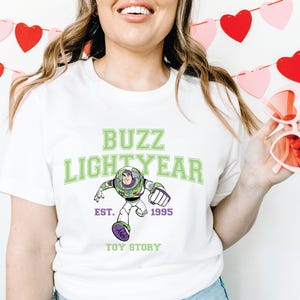 a woman wearing a buzz lightyear t - shirt