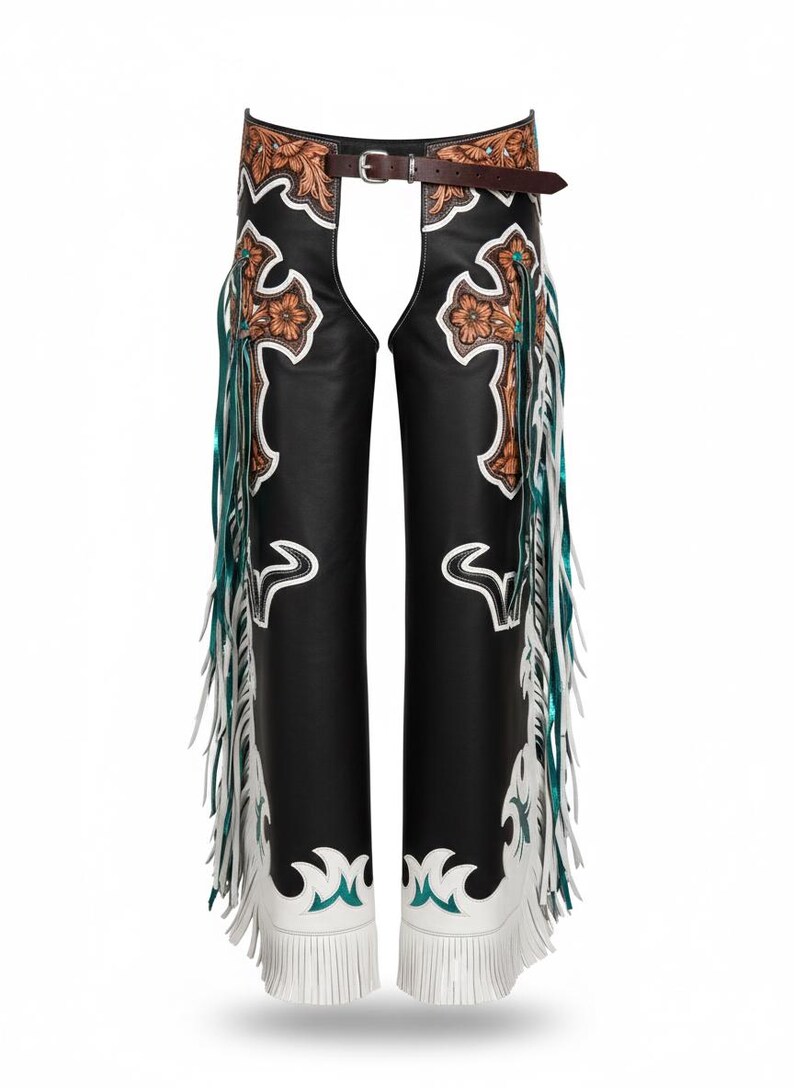 May include: Black leather chaps featuring a brown tooled leather waistband and upper thigh panels with floral cross motifs. The legs are accented with white leather overlays, turquoise trim, and long white and metallic teal fringe along the sides.