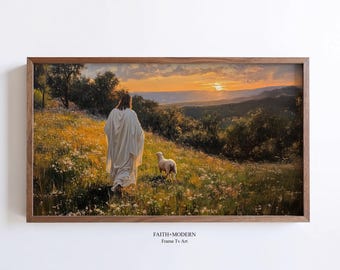 May include: A painting of Jesus walking through a field with a white lamb following him. The sun is setting in the background, casting a warm glow over the scene. The painting is framed in a dark wood frame.