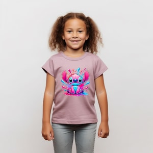 May include: A pink t-shirt featuring a cartoon blue and pink Stitch character in a colourful paint splatter design.
