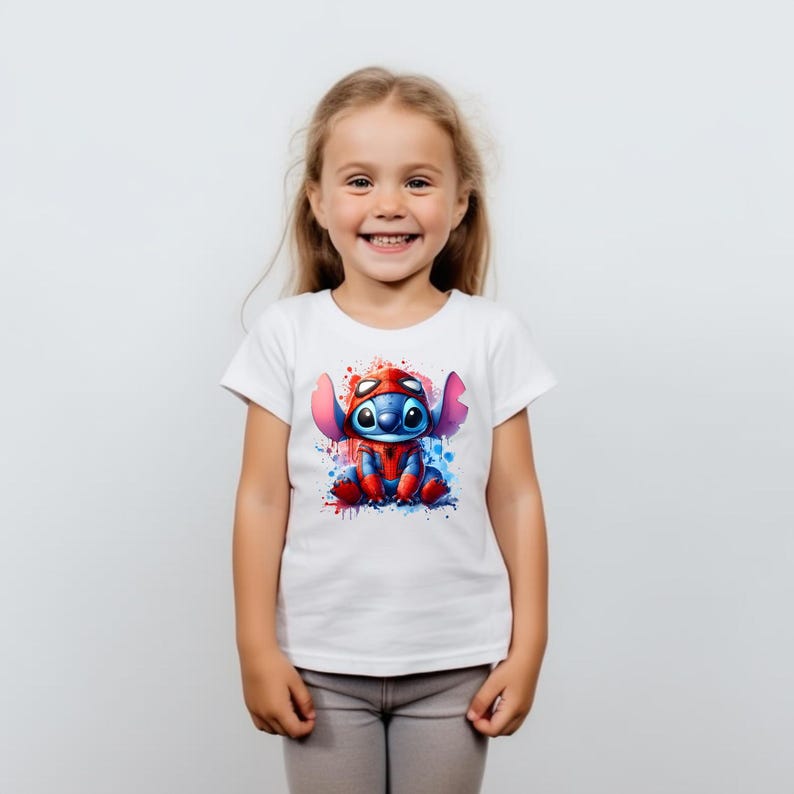 May include: A white t-shirt with a blue and red cartoon character wearing a red and blue suit. The character is surrounded by blue, red, and white paint splatters.