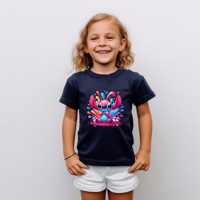 May include: A navy blue t-shirt featuring a colourful graphic of a cartoon character, Stitch, surrounded by paint splatters.
