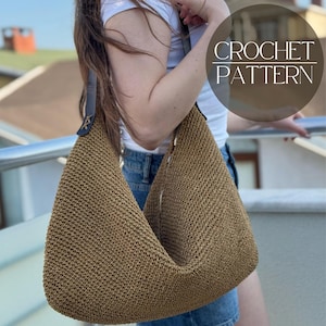 May include: A brown crochet shoulder bag with a zipper closure and a dark strap. The bag is made of a woven material and has the text "CROCHET PATTERN" in a circular design.