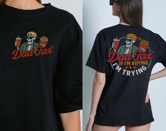 May include: Black t-shirt featuring a skeleton wearing sunglasses and a cap, holding a drink and fries, with the text "Dad Tax" in red and orange. The back of the shirt has the same design with the text "If I'm buying, I'm trying."