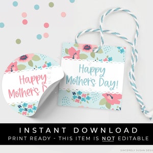 May include: A set of Mother's Day gift tags and stickers. The tags and stickers feature a floral pattern with pink and blue flowers on a light blue background. The text "Happy Mother's Day!" is displayed in a script font. A white scalloped border frames the text.