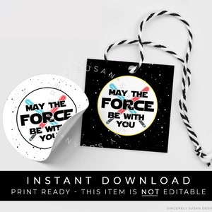 May include: Printable gift tags with a black and white space background and a yellow circle with the text "May the Force be with you" and a red and blue lightsaber design. The tags are ready to print and are not editable.