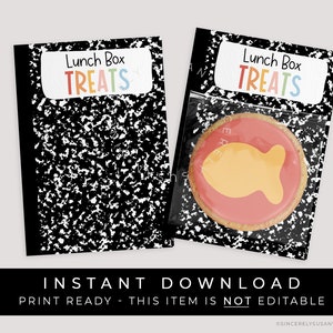 Può includere: Etichette stampabili per sacchetti di dolcetti per la scatola del pranzo con un design di carta per quaderni nero e bianco. Le etichette hanno il testo "Lunch Box Treats" in lettere arcobaleno. L'immagine mostra anche un biscotto con un design di pesce rosa e arancione.