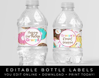 May include: Two clear plastic water bottles with colorful donut-themed labels. The labels feature pink, blue, yellow, and brown donuts with sprinkles. One label says "Happy Birthday Gracyn" and the other says "Gracyn's Donut Shoppe".
