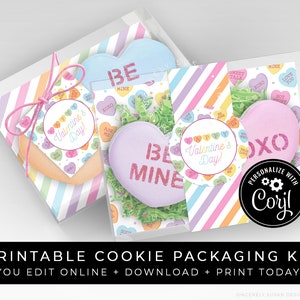 May include: Printable Valentine's Day cookie packaging kit with colorful striped boxes, heart-shaped cookies, and tags. The tags feature candy hearts with phrases like "Happy Valentine's Day!" and "Be Mine".