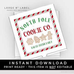 May include: A white 8-inch square label with red and green stripes around the border. The label says "North Pole Cookie Co." in red letters with a gingerbread man, a snowflake, and a Christmas tree cookie graphic. The text "Baked Fresh Daily" is printed in black letters below the cookies.