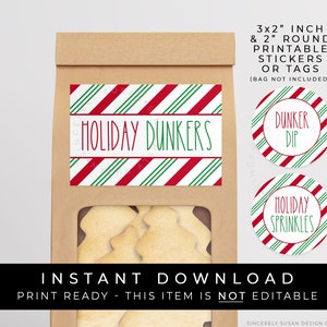 May include: A brown paper bag with a window, containing cookies. The bag features a label reading "HOLIDAY DUNKERS" with red and green stripes. Two round stickers say "DUNKER DIP" and "HOLIDAY SPRINKLES". The text "INSTANT DOWNLOAD" is also visible.