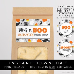 May include: Printable Halloween-themed stickers and tags. The stickers feature a grey background with black bats, white ghosts, orange pumpkins, and yellow candy corn. The text on the stickers reads "Dunk a Boo Halloween Dunker Cookies", "Boo Dip", and "Spooky Sprinkles".