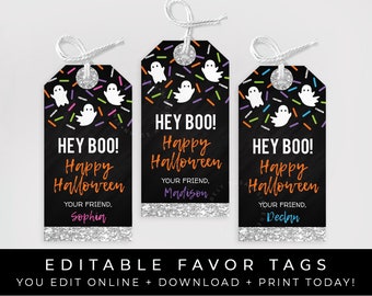 May include: Three printable Halloween favor tags with a chalkboard background and silver glitter accents. The tags feature a ghost and colorful sprinkles. The text on the tags reads "Hey Boo! Happy Halloween" and includes a space to personalize with a name.