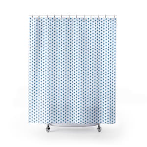 May include: A white shower curtain with a repeating pattern of small blue hearts.