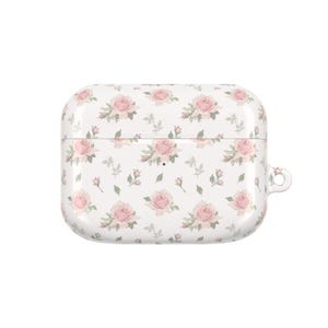 May include: White protective case for wireless earbuds, adorned with a repeating pattern of pink roses and green leaves. The case has a rounded rectangular shape with a small loop on the side for attaching to a keychain or lanyard.