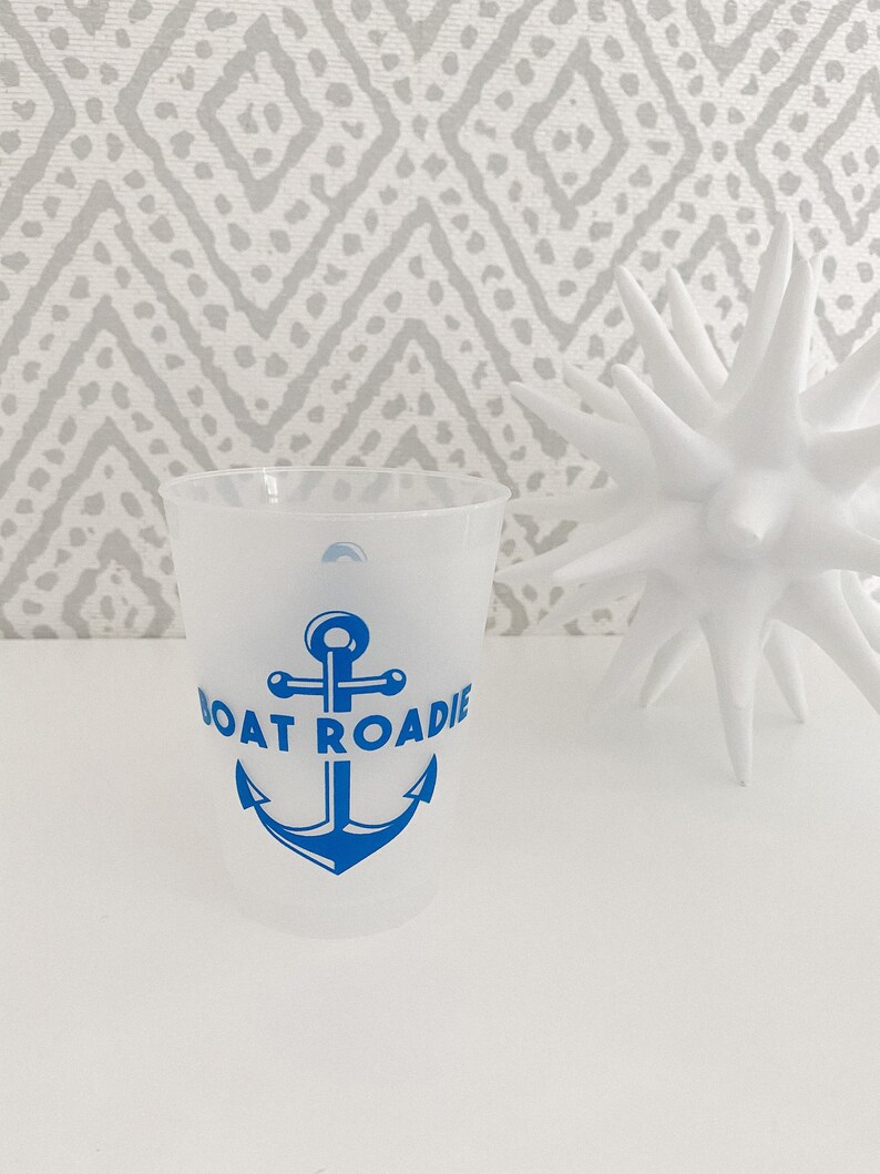 May include: A white plastic cup with a blue anchor and the text "Boat Roadie" printed on it.