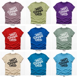 Flatlay display of Gildan 64000 t-shirt mockup bundle in over 50 colors, showcasing various blank shirts including black, red, orange, purple, yellow, green, mint, and pink, each with 'Your Design Here' placeholder text for custom design previews.