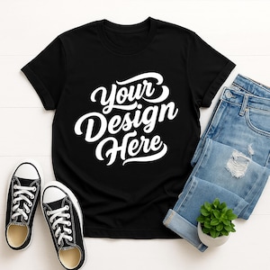 Mockup bundle featuring Gildan 64000 t-shirts in over 70+ colors. The image shows various colored t-shirts with the placeholder text 'Your Design Here' on a flat lay background with flowers, sneakers, and other accessories.