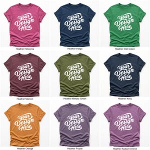 Flatlay display of Gildan 64000 t-shirt mockup bundle in over 50 colors, showcasing various blank shirts including black, red, orange, purple, yellow, green, mint, and pink, each with 'Your Design Here' placeholder text for custom design previews.