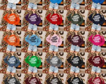 May include: A selection of crew neck sweatshirts in a variety of colours, each printed with the text "Your Design Here". The sweatshirts are modelled with denim shorts, with a Christmas tree in the background.