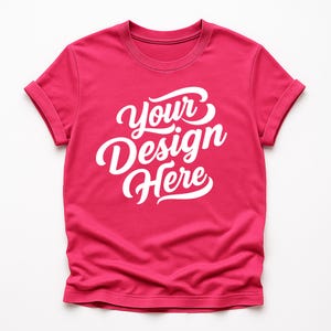 Flatlay display of Gildan 64000 t-shirt mockup bundle in over 50 colors, showcasing various blank shirts including black, red, orange, purple, yellow, green, mint, and pink, each with 'Your Design Here' placeholder text for custom design previews.