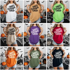May include: Nine different colored t-shirts, each with the text "Your Design Here" in a stylized font. The shirts are in various colors, including white, tan, mustard, green, purple, red, orange, olive green, and black. Halloween decorations are in the background.