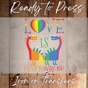May include: A colorful iron-on transfer featuring the text "LOVE IS NEVER WRONG" with a rainbow heart and two dinosaur illustrations. The words "Ready to Press" and "Iron on Transfers" are also included.