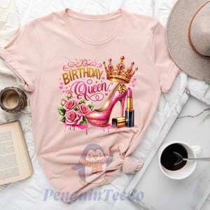 May include: Pink t-shirt with a graphic design of a pink high heel shoe, a crown, and the text "Birthday Queen".
