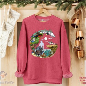 A red sweater with a colorful graphic design hangs on a wooden hanger, surrounded by Christmas stockings and ornaments.