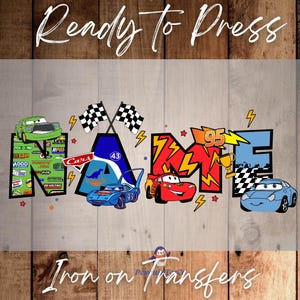 May include: Iron-on transfer design featuring the word "NAME" with Cars characters, including Lightning McQueen, Mater, and a blue race car. The letters are decorated with racing-themed graphics, such as checkered flags, lightning bolts, and numbers.