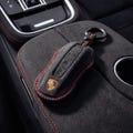 Porsche Alcantara Key Cover | Black And Red Stitching |  Custom Key Fob Case for 911, Macan, Cayenne, Panamera, Taycan product logo