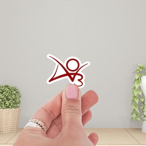 May include: Red vinyl sticker with a stylized figure with outstretched arms and a circle for a head.