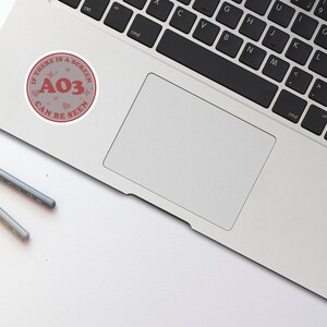 May include: A pink and white sticker with the text "If there is a screen, AO3 can be seen" and the number "AO3" in red.