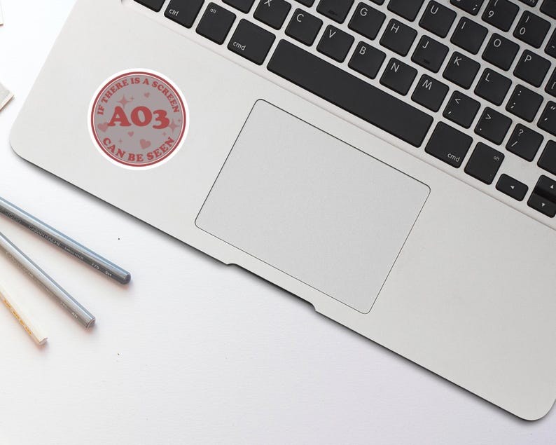 May include: A pink and white sticker with the text "If there is a screen, AO3 can be seen" and the number "AO3" in red.