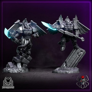 May include: Two detailed, silver figurines of winged warriors in dynamic poses, each wielding a glowing blue blade. The figures stand on textured, rocky bases against a dark purple background. The text "pre-supported" is visible.