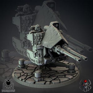 May include: A detailed, gray miniature war machine with a double-barreled cannon, mounted on a textured base. The model features intricate armor plating, a protective shield, and a detailed figure in the cockpit. The base has a pre-supported logo.