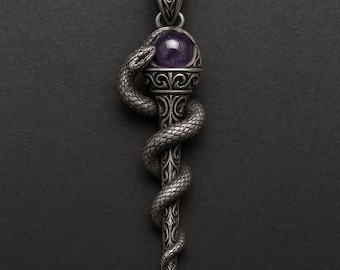 May include: A silver pendant featuring a detailed snake coiled around a staff, with a purple gemstone at the top. The pendant has intricate patterns and a pointed bottom, suitable for jewelry or gothic-themed accessories.