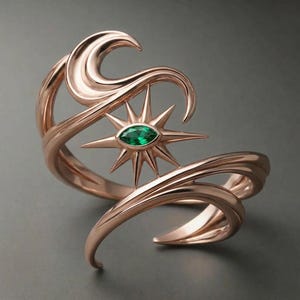May include: Rose gold-toned cuff bracelet featuring a starburst design with a central, oval-cut emerald-green gemstone. The bracelet has a flowing, wave-like design with curved lines and a polished finish, creating an elegant and artistic look.