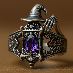 May include: A silver-toned ring featuring a witch's hat and a skeleton hand design. The ring has an ornate frame with a large, oval-cut purple gemstone. The ring is a unique piece of jewelry.
