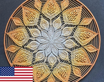 May include: A circular, handmade doily with a detailed, symmetrical design. The doily features a gradient of colors, transitioning from a light cream center to shades of yellow and orange at the edges. The intricate pattern includes diamond and petal shapes.