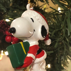 Vintage Santa Snoopy Carrying a Green Christmas Present Ornament