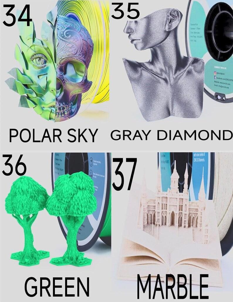 May include: Four 3D printing filament spools with corresponding printed models: 34 Polar Sky shows a split face and skull, 35 Gray Diamond features a glittery bust, 36 Green displays two trees, and 37 Marble depicts an intricate open book structure.