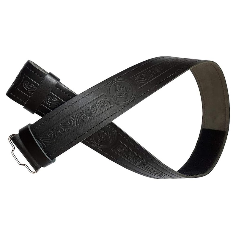 May include: Black leather belt with embossed scrollwork and Masonic symbols. The belt features a silver-colored buckle and a hook-and-loop closure. The belt is approximately 1.5 inches wide.
