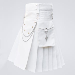 May include: A white kilt with a pleated design, featuring a pocket, metal chain, and decorative rivets. The kilt has a belt with metal hardware and a front flap. The overall design is modern and stylish.