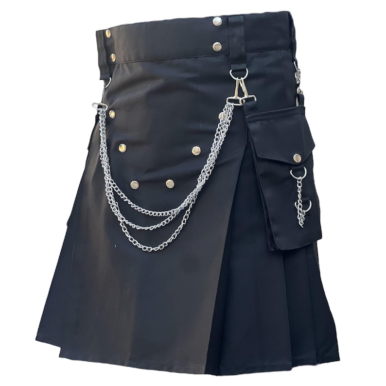 May include: Black kilt with silver chain detailing and a small pocket. The kilt features silver button accents and a belt with silver hardware. The pleats are visible, and the kilt appears to be made of a sturdy material.
