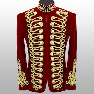May include: A red velvet jacket with gold decorative trim. The jacket has a high collar and gold rope and button detailing down the front and on the sleeves. The jacket is displayed on a mannequin.