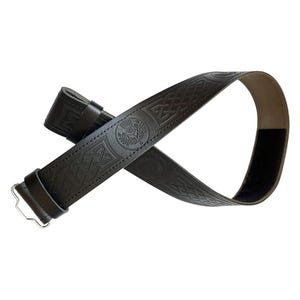 May include: A black leather belt with embossed Celtic knot patterns and a thistle emblem. The belt features a silver-colored buckle and a Velcro closure. The design is suitable for kilts or other traditional attire.