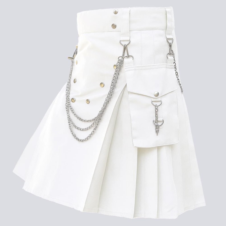 May include: A white kilt with pleats, a pocket, and silver-tone chain accents. The kilt features a belt with silver-tone hardware and decorative rivets. A silver-tone chain hangs from the belt to the pocket.