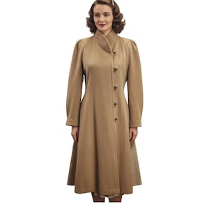 May include: A tan-colored vintage coat with a high collar and button-down front. The coat features long sleeves, a fitted waist, and a flared skirt. The skirt has a patterned fabric detail at the hem. The coat is knee-length.
