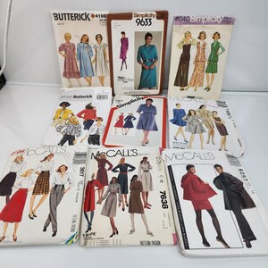 May include: A collection of vintage sewing patterns from brands like Butterick, Simplicity, and McCall's. The patterns feature illustrations of dresses, suits, and other garments. The covers display various colors and styles, with text indicating sizes and prices.